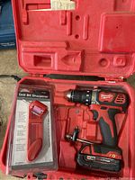 Milwaukee cordless drill/driver in red plastic case with drill bit sharpener package included.