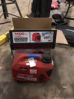 Generator and original box placed on concrete floor