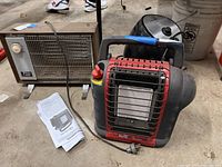 Photo showing Titan infrared heater with temperature control and brand label, Mr. Heater portable heater in front with power cord, and Farberware air fryer behind