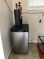 Full front view of Danby kegerator with CO2 cylinder and tap assembly mounted on top