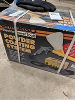 Boxed Chicago Electric Powder Coating System with spray gun and bag, showing product label and brand