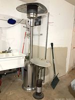 Wide shot showing both patio heaters side by side in garage space