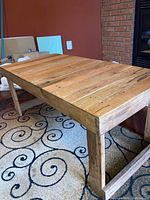 Overall angled side view showing the wooden slatted top and sturdy solid wood leg supports.