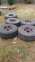 Overview of four tires and rims on grass