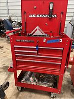 Front view of red U.S. General locking rolling tool chest with top lid open showing tools inside