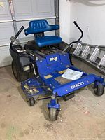 Front-side view showing mower deck, seat, lap bars, caster wheel and overall condition