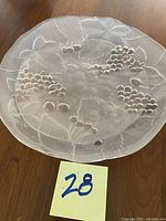 Top view of 12.5" glass platter showing etched grape clusters and leaves on translucent glass