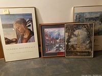 Five framed prints arranged together showing Botticelli Madonna, a Lowell scene, and Salisbury Cathedral among others.