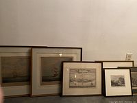 Photo showing all six framed prints together, including the nautical and historic scenes.