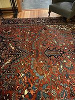 Central field of rug showing Tree of Life design with burgundy, blue, cream motifs and geometric floral elements.
