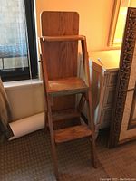 Wooden chair configuration showing seat, armrests, and backrest