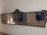 Full view of the antique 3-panel wall mirror showing the length and overall carved wood frame.