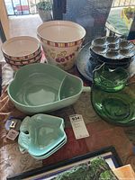 Photo showing ceramic popcorn bucket, ceramic bowls, green glass serving dishes, light green ceramic dishes, and metal serving trays.