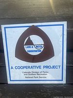 Front view of the square metal sign showing the Land & Water Conservation logo and text.