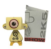Front view of yellow MAD*L Mimic figure with original box showing light wear.