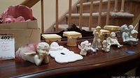 Overview of all angels and decorative columns on table, showing size and condition.