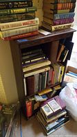Wooden bookcase filled with books showing overall condition and wear