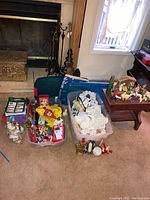 Full view including storage bins filled with various Christmas ornaments and decor, nativity scene on small wooden table.