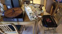 Full lot on table showing all items including lazy Susan, chair covers, trays, decanters, and silverware chest