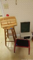 Lot showing all four items including the wooden stool, wooden organizer on stool, Sentry safe, and red step stool.