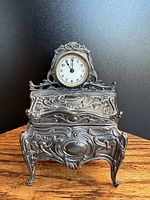 Front view of the Jennings Brothers Art Nouveau jewelry casket showing the detailed metalwork and integrated clock