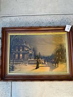 Full view of the framed English Victorian winter scene print with snow, house with mansard roof, people, and horse carriage.