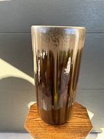 Tall glazed porcelain umbrella holder shown from a front angle with natural light highlighting the glossy finish and color gradient.