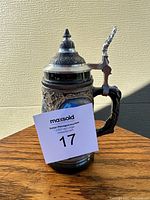 Side view of the German beer stein showing detailed relief and pewter lid