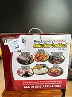 Back of box highlighting various cooking modes: indoor grill, deep fryer, pressure cooker, fondue maker, steamer, slow cooker, all-in-one appliance.