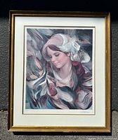 Full view of framed signed print showing woman with abstract brushstroke background.