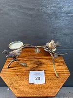 Full view of the metal candle holder with birds, displaying overall design and structure.
