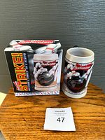 Front view of boxed Budweiser Strike! Bowling Stein showing detailed bowling pins and ball design with Budweiser branding, indicating collectible beer stein.