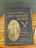 Front cover of vintage book with title 'Lest We Forget Complete Story of the San Francisco Horror' with embossed gold text and illustration.