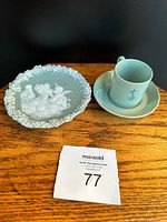 Photo of porcelain cup with anchor symbol alongside matching saucer