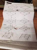 Assembly instruction sheet showing steps to build the three-tier planter, illustrating frame and platform assembly.