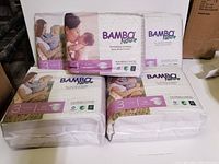 Bambo Nature diapers lot including three size 3 packs, one size 2 pack, and one size 1 pack displayed together.