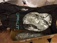 Black Creality branded fabric tent cover with clear window.