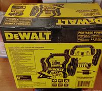 Sealed retail packaging for DeWalt DXAEPS14CA portable power station showing branding and product illustration