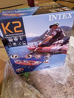 Front of box showing Intex Excursion Pro K2 branding and product illustration of kayak on water