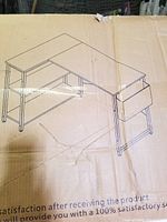 Cardboard packaging printed with Homieasy logo and line drawing of the assembled L-shaped desk