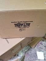 Close-up image of product box labeled with Tripp Lite brand and manufacturing information.