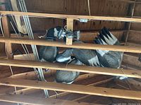 Several Canada goose decoys hanging in rafters of a garage, showing their molded details and coloration.