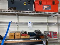 Overall view of shelf with jig, wooden bit boxes, plastic cases and sanding drum kits