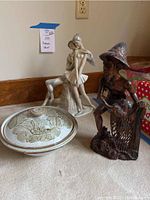 Photo showing all three items: ballet dancer statue, pottery dish with lid, and wood carved man sculpture.
