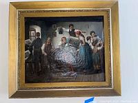 Front view of framed oil painting showing the group scene and gilded frame.