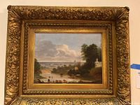 Front view of vintage landscape oil painting in ornate wood frame