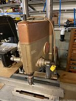 Front view of ShopSmith power head mounted on vertical columns above metal work table