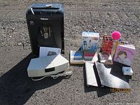 Photo showing Fellowes shredder, VTech answering system box, Bose Wave Radio, and assorted office and media items
