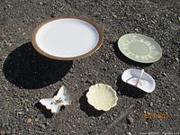Wide view showing all five items including Bavaria pedestal cake plate with gold trim, vintage Wedgwood cake plate, Belleek flower dish, Spode rose spray basket, and ESD Japan divided dish.