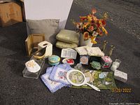 Photo showing entire lot including floral arrangement, napkins, bowls, coasters, and decorative objects.